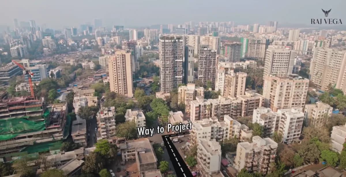 Drone view of city buildings with a way-to-project route drawn on the road